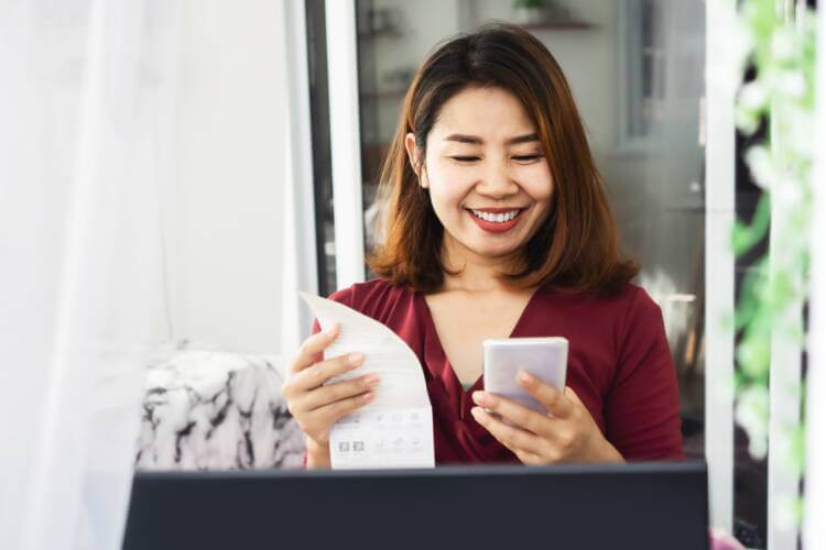 Woman Smiling at electricity bill